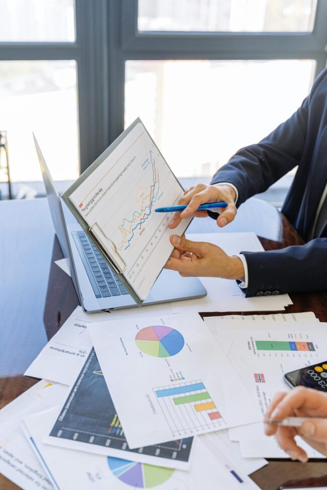 Data-Quality-is-Your-Small-Businesss-Secret-Weapon-scaled.jpg Free Business professionals discussing financial graphs and charts in an office setting. Stock Photo