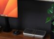a desk with a laptop, keyboard, mouse and a monitor