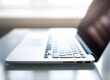 Free Elegant side view of a laptop on a glossy table with natural lighting indoors. Stock Photo