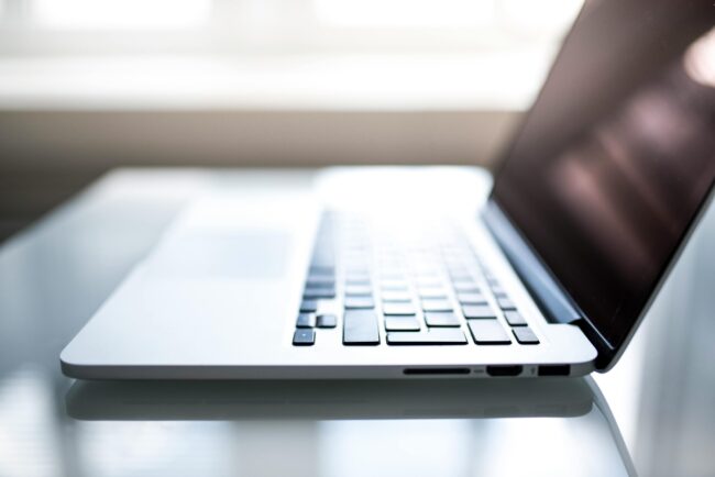 What-Your-Small-Business-MUST-Know-About-Data-Regulations-in-2025-scaled.jpg Free Elegant side view of a laptop on a glossy table with natural lighting indoors. Stock Photo