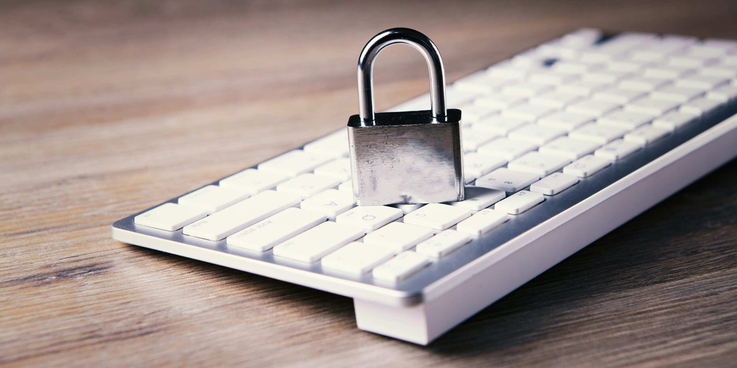 Your-2025-Privacy-Compliance-Checklist-and-What-You-Need-to-Know-About-the-New-Data-Laws-scaled.jpg a computer keyboard with a padlock on top of it